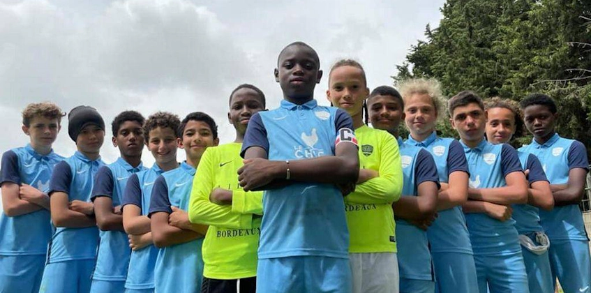 Ποικιλόμορφη νεανική ποδοσφαιρική ομάδα ποζάρει με αυτοπεποίθηση για το Κύπελλο Μεσογείου.