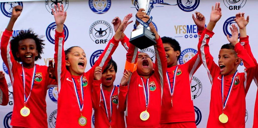 Young soccer players celebrating a win at the UK International Cup event