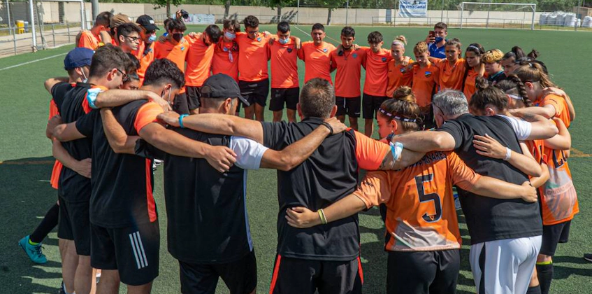 Football team in huddle showing unity before a Costa Levante Cup match.