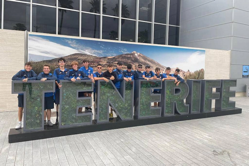 Soccer team posing in front of the TENERIFE sign at the Canarias Cup.