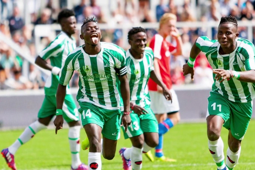 Soccer players in green and white jerseys celebrate a goal at Dana Cup Hjørring