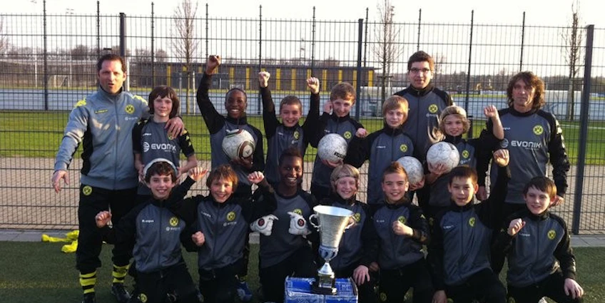 Youth soccer team celebrating with trophy at Young Talents Cup