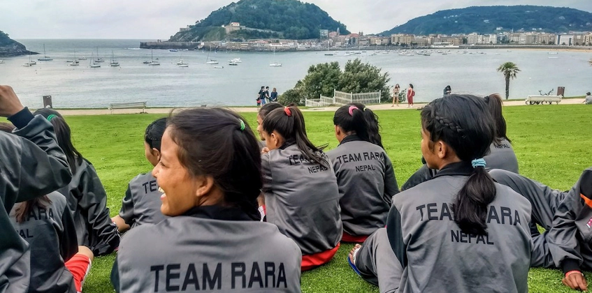 Women's football team Team RARA Nepal resting with sea view in background