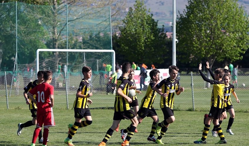 Youth football team celebrating a goal at the Balkan International Cup tournament
