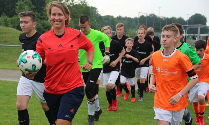Football teams making their way onto the pitch at Oranje Cup event