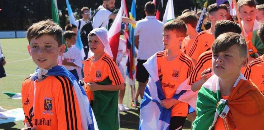 Young soccer players with flags at Copa Cataluña tournament